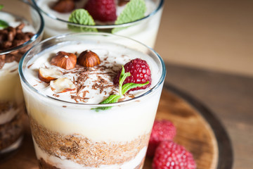 Dessert with berries, jelly, cream, nuts and mint leaf 