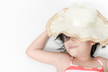 girl wearing swimsuit with hat and sunglasses lying