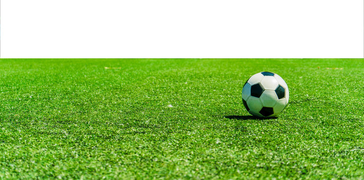 Soccer ball on grass against white background