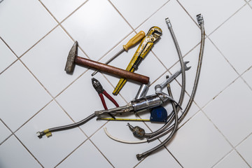 Fototapeta na wymiar specialist male plumber repairs faucet in kitchen