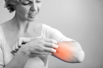 Woman Scratching an itch on white background . Sensitive Skin, Food allergy symptoms, Irritation