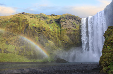 Skogafoss waterfall with rainbow in Iceland