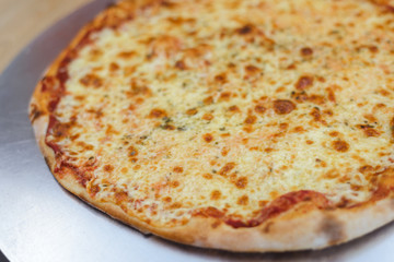 Closeup on traditional fresh pizza, top side view wooden background