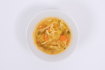 Noodle soup with vegetables on a white