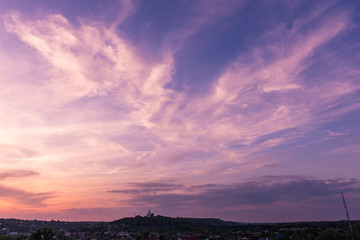 Sunset blue magenta violet yellow sky in Poltava, Ukraine rural countryside landcape with church; siluette; city town scenery