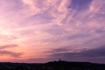 Sunset blue magenta violet yellow sky in Poltava, Ukraine rural countryside landcape with church; siluette; city town scenery