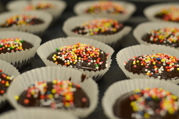 Tasty birthday chocolate cupcakes with chocolate and candies on top 