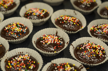 Tasty birthday chocolate cupcakes with chocolate and candies on top 