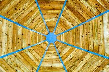 An octagonal wooden roof.