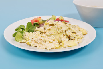 Baked zucchini vegetable salad on a white