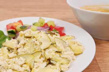 Baked zucchini vegetable salad on a white