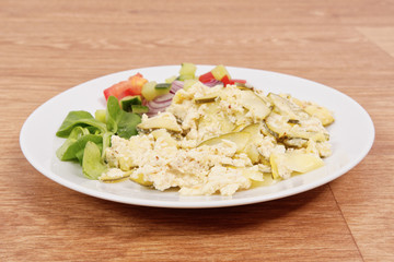 Baked zucchini vegetable salad on a white