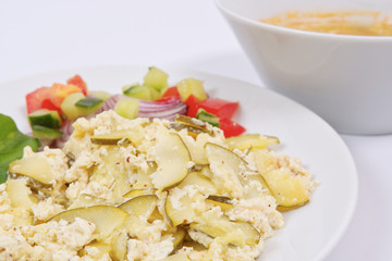 Baked zucchini vegetable salad on a white