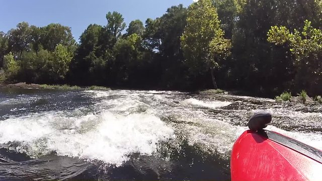Kayak through medium rapids
