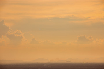 Fototapeta na wymiar Evening weather, Sunset sky, Dark shadow meadow in the field and far away as a mountain.