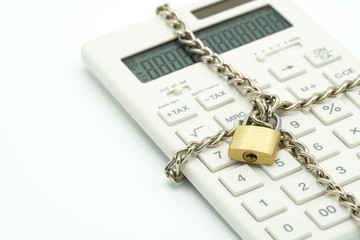 Lock and chain lock, white calculator, lock concept, financial account, bank account, white space, add text message, Can not be financially motivated Calculations
