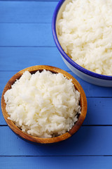 Close up image of cooked jasmin rice on blue wooden background