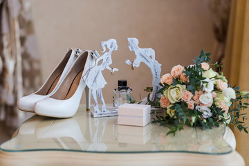 high heel wedding shoes and bouquet as bridal accessories