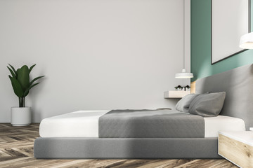 White and green bedroom with poster, side view