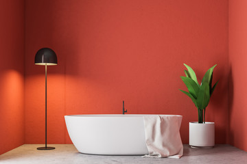 Fototapeta na wymiar Minimalistic red bathroom, white bathtub