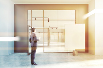 White wall poster gallery, glass door, businessman
