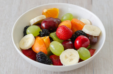  Healthy fresh fruit salad in white plate. Top view.