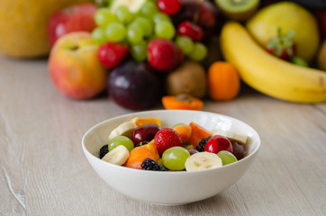  Healthy fresh fruit salad in white plate. Top view.