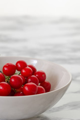 Fresh red cherries in white plate.