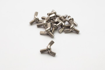 Hardware parts stainless steel winged screw bolts on white background.