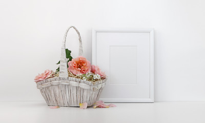 Fototapeta na wymiar Blank picture frame mockup with a basket of roses