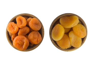 Two bowls with dried apricots in a wooden bowl isolated on white. Dried fruit with copy space for text. Top view. 
