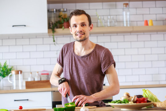 Image of man cooking vegetables on table