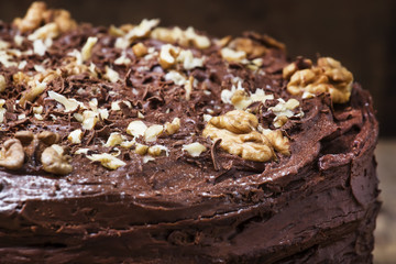 Homemade chocolate cake with nuts, rustic background, selective focus