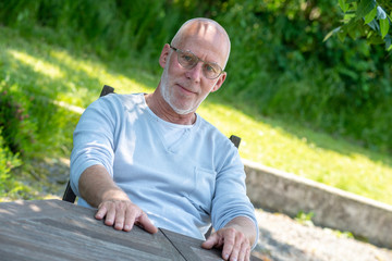 Naklejka na ściany i meble portrait of senior man with glasses, outdoors