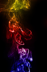 abstract fragment movement of colorful red blue and yellow gradient smoke on black background.