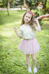Young girl holds with big colourful lollipop. summertime and happy childhood concept. Funny girl.
