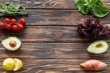 top view of arrangement of fresh and ripe vegetables on wooden surface