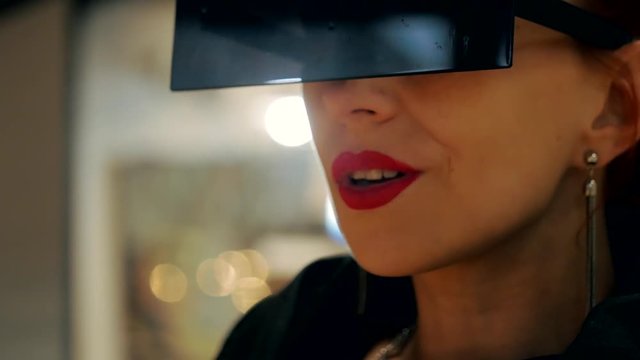 Beautiful stylish young woman with fashion sunglasses and red lips in the mall close-up