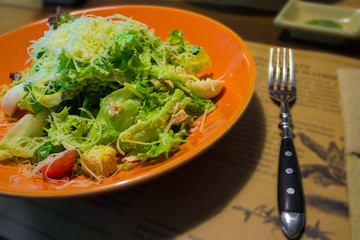 Caesar salad in a plate on the table