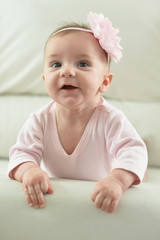 Cute charming girl with a flower on her head