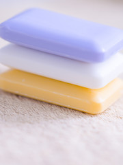 three bars of soap on a towel