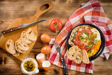 Homemade breakfast fried egg with tomato.