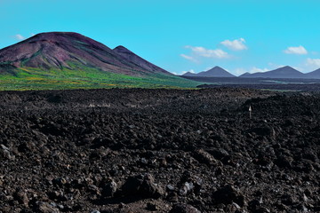 Volcanic landscape and beatiful blue sky with incredible clouds in Timanfaya National Park, Lanzarote, Canary Islands, Spain