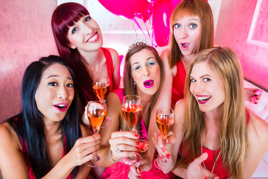 Bride and friends celebrating hen night with champagne in club 
