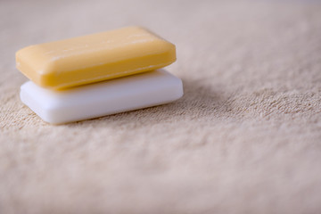 Two bars of soap on a towel