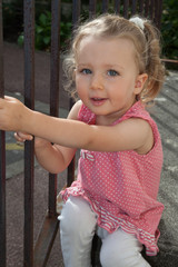 young little girl with beautiful curly blond hairs laughing