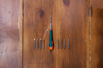 screwdriver lies on wooden boards