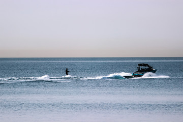 Wakeboading at front of tanker at midday