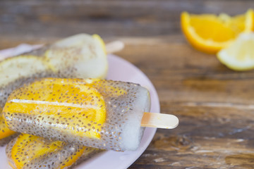 Popsicle of orange and lemon with chia