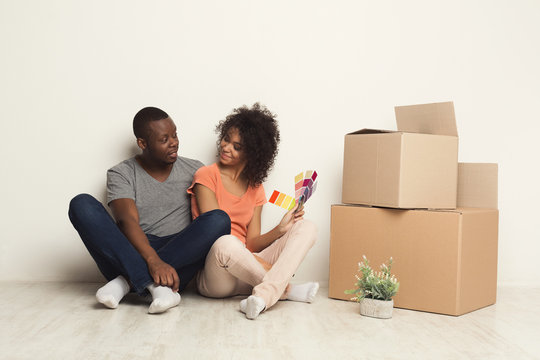 Black couple sitting on floor at new apartment